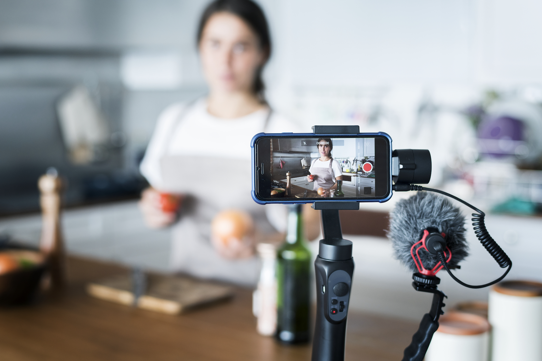 Female vlogger recording cooking related broadcast at home